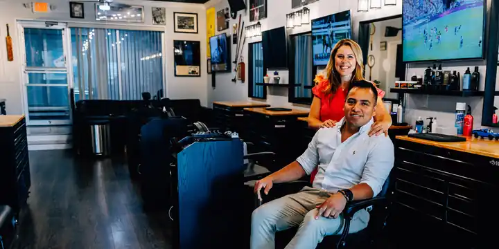 Alberto and Shauna Mendoza, owners, inside The Final Cut Sports Barbershop